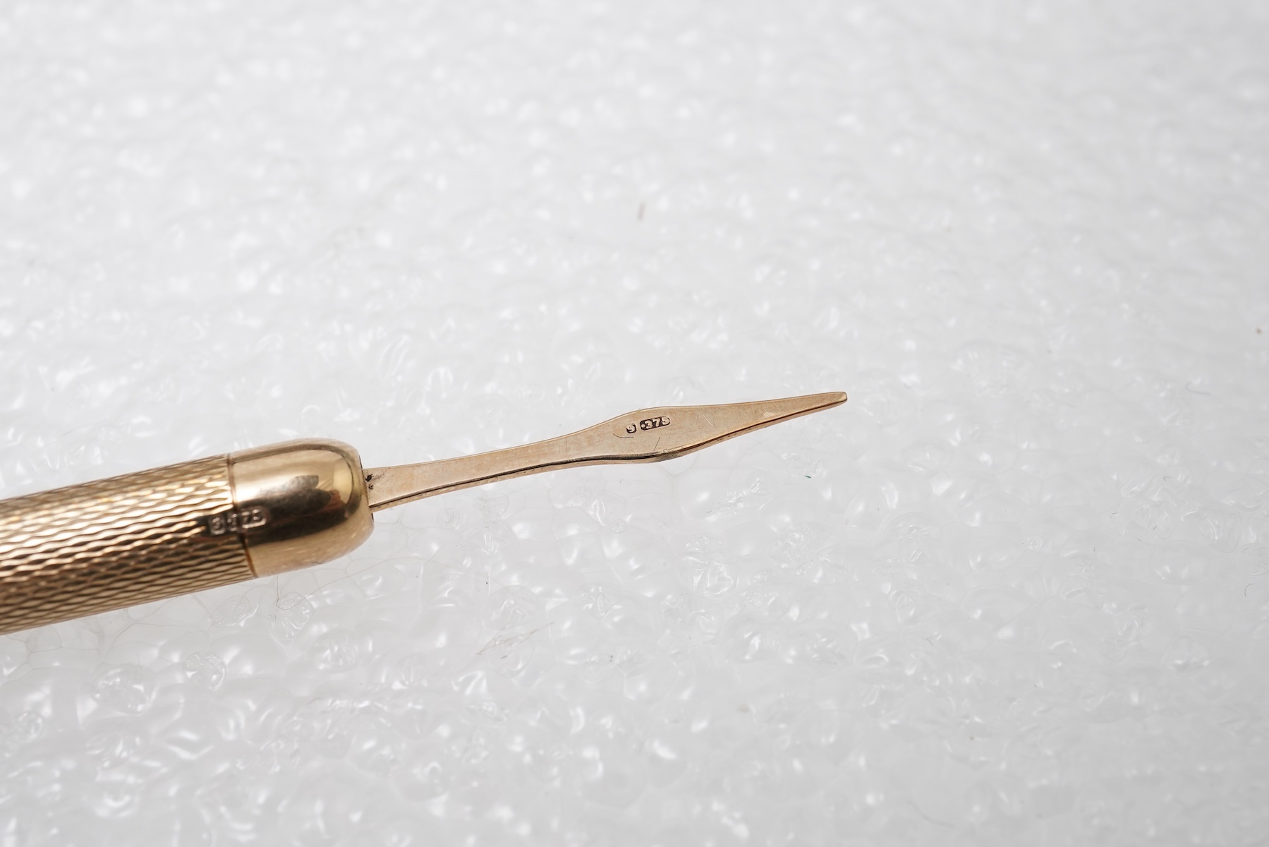 A gold watch chain, toothpick and fob seal